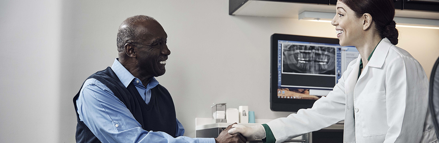 man and dentist sharing a handshake