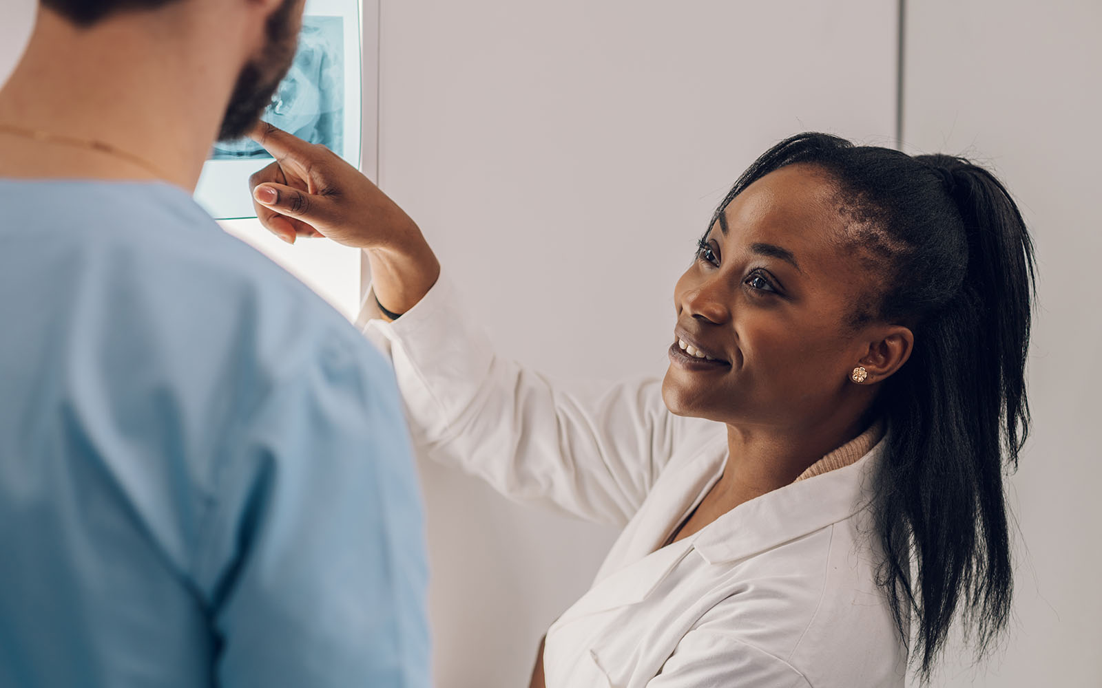 Group of doctors looking at x-ray image from jaw