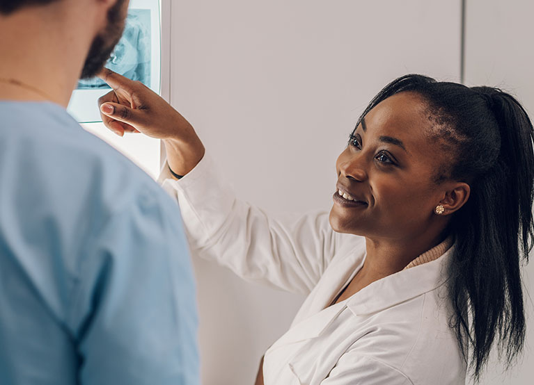 Group of doctors looking at x-ray image from jaw