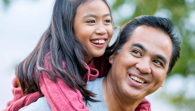 little girl and dad laughing