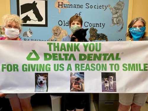 oldham community humane society volunteers with thank you sign-mobile.jpg