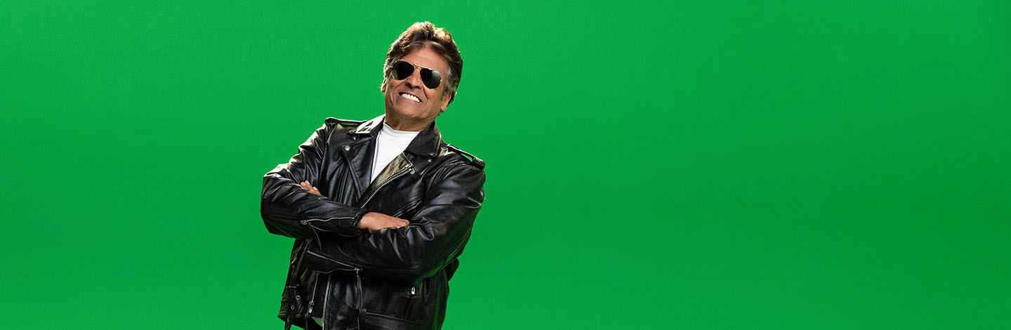 Erik Estrada looking at camera wearing sunglasses and smiling