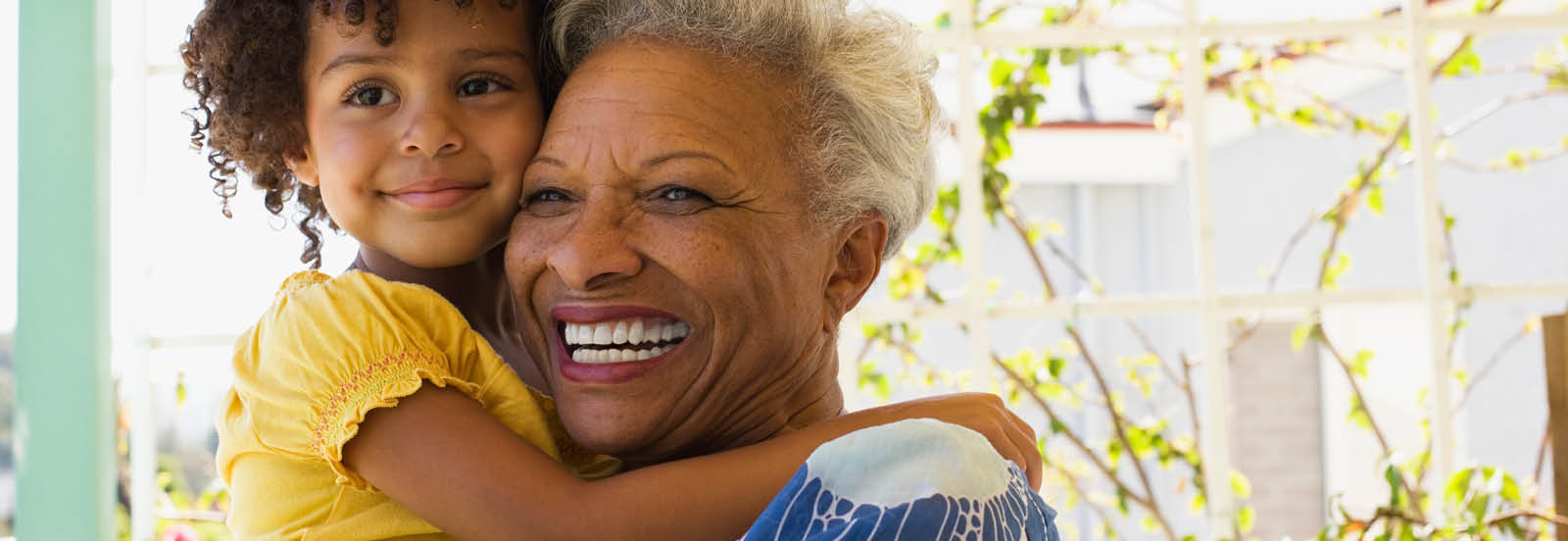 Grandmother holding granddaughter and smiling