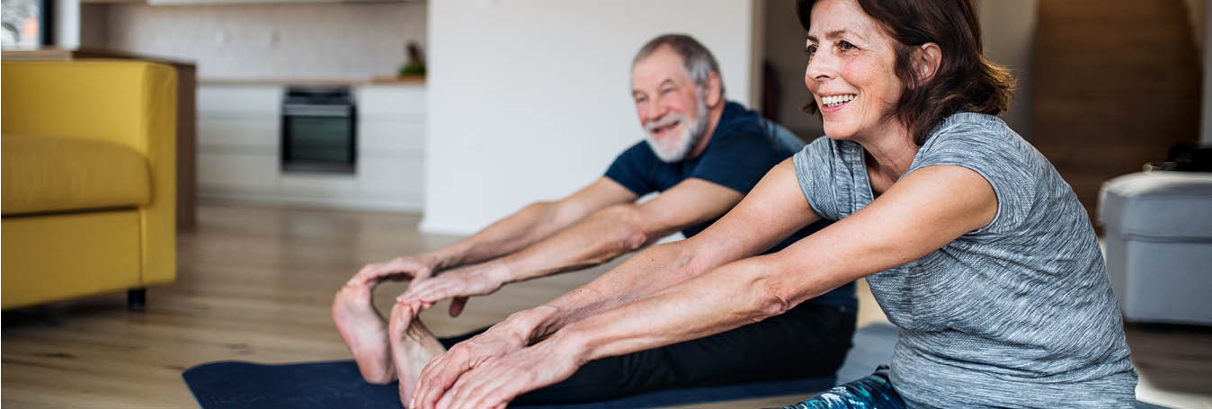 husband and wife doing yoga together staying healthy 1348X455.jpg