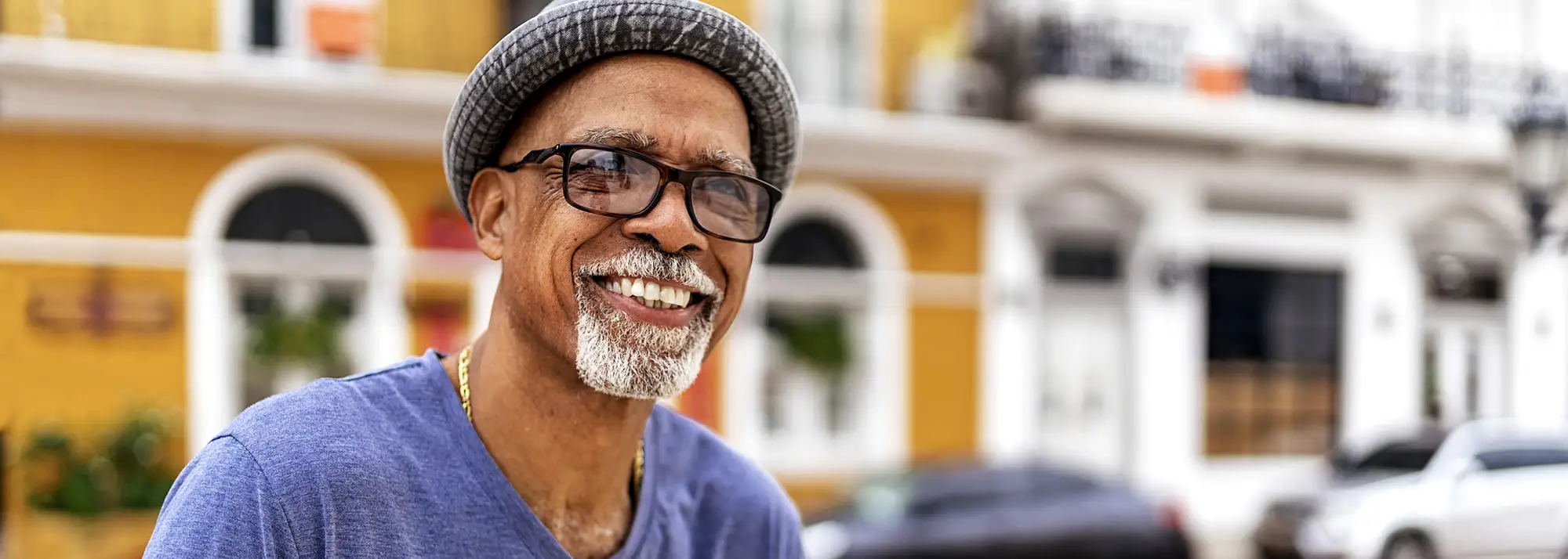 man with glasses smiling 2000x714.webp