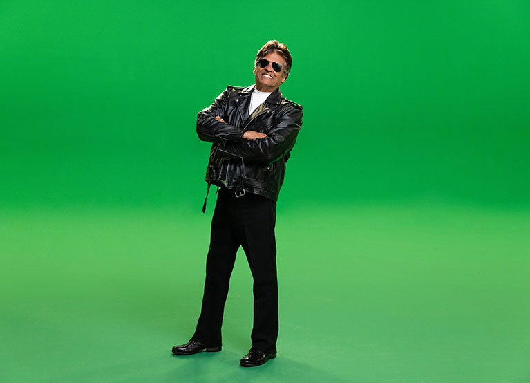 Erik Estrada looking at camera wearing sunglasses and smiling
