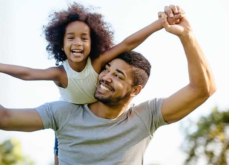 father giving daughter piggyback ride-mobile.jpg