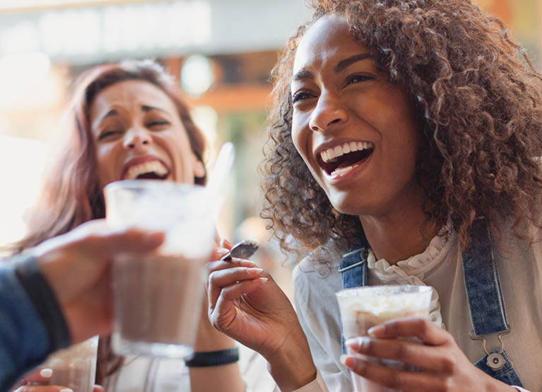 woman and friends drinking sugary drinks oral health mobile 767x554.jpg