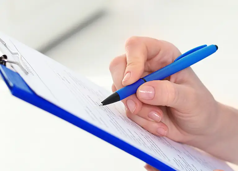 woman checking pre estimate dental on clipboard