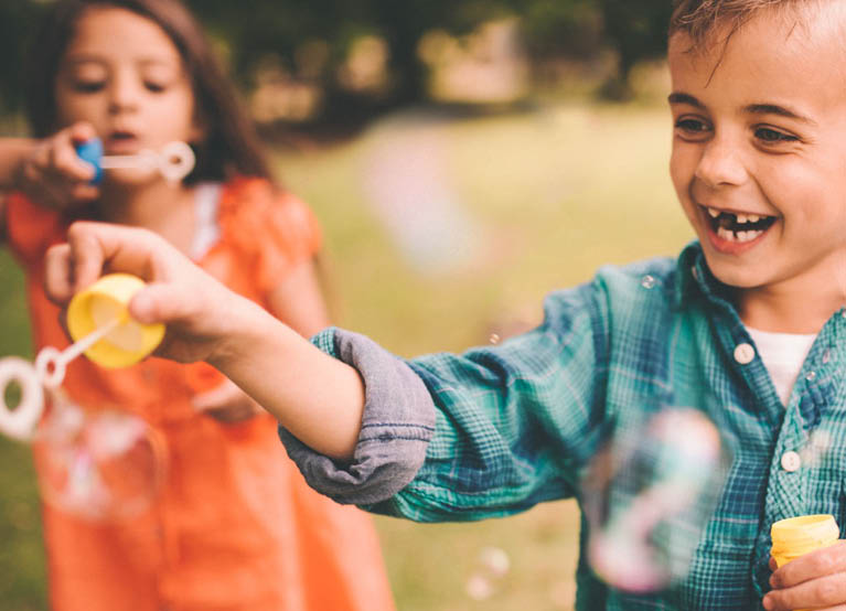 young children playing outside with bubbles mobile 767x554.jpg