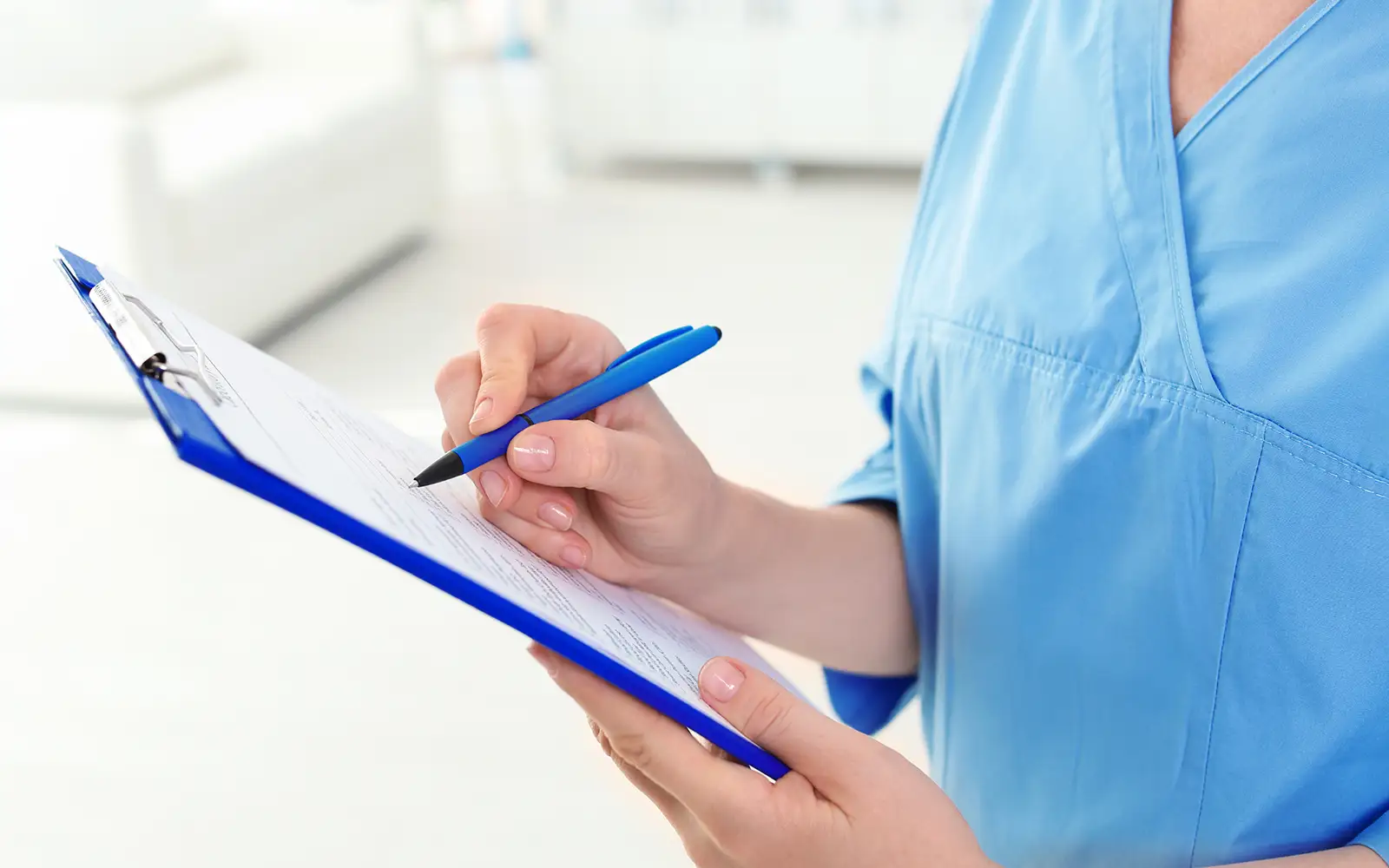 woman checking pre estimate dental on clipboard