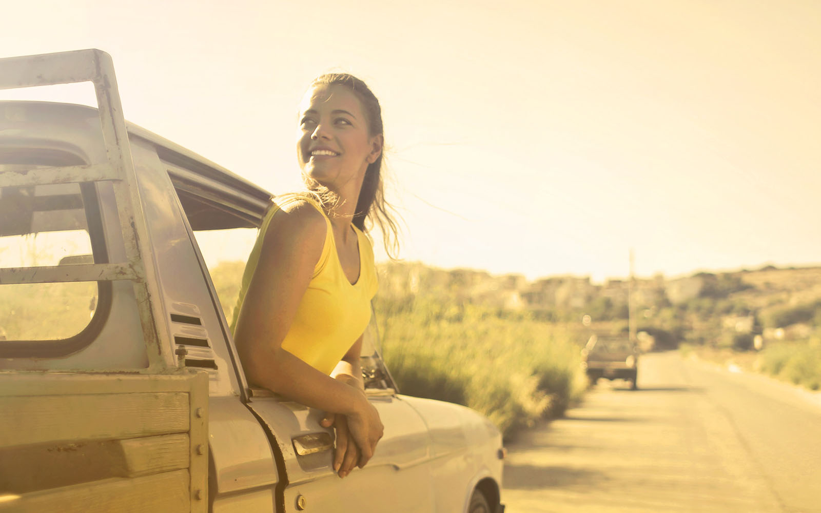 woman riding in a truck at sunset tablet.jpg