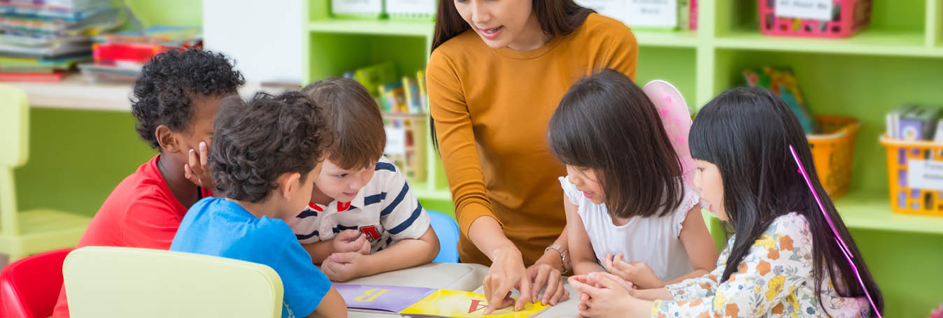 teacher and kids in school 1348X455.jpg