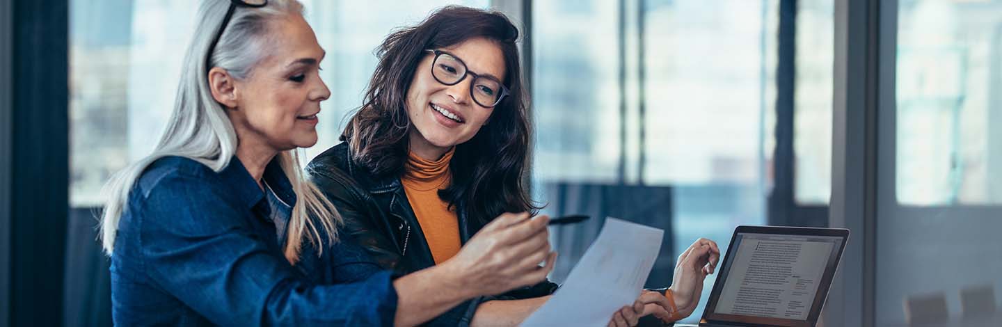 two female employees looking at paperwork.jpg