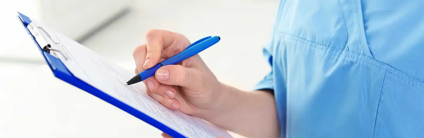 woman checking pre estimate dental on clipboard