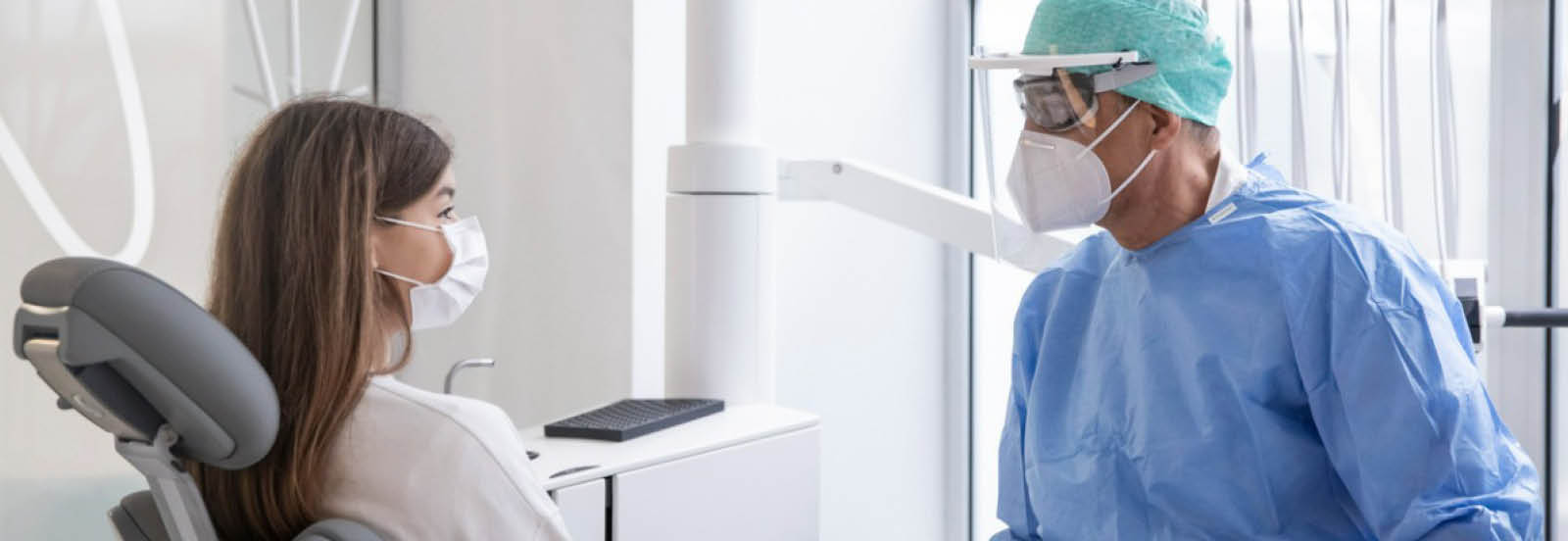 young woman talking to her dentist desktop 1600x552.jpg