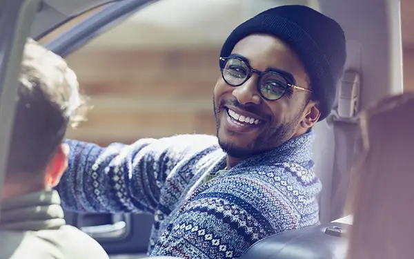 man with glasses in car