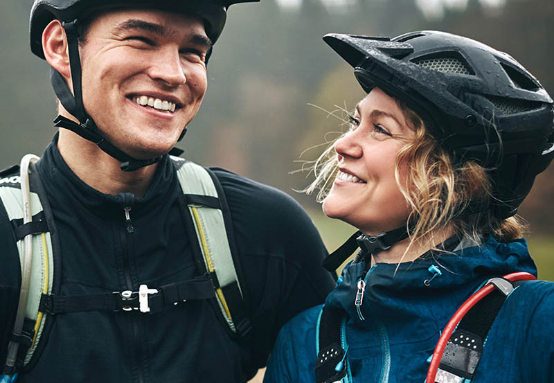 two healthy people biking and smiling.jpg