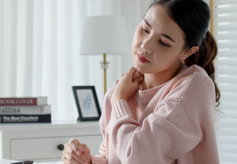 young asian woman rubbing shoulder from stress at work desktop 800x553.jpg
